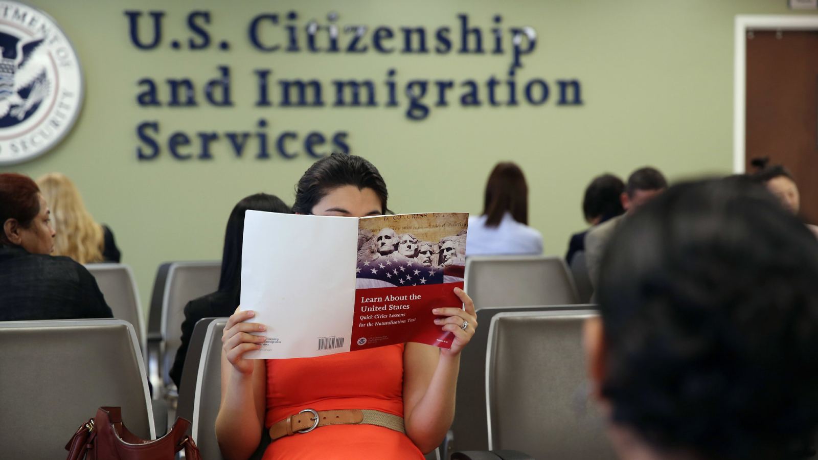 A couple waiting nervously during a US immigration interview.