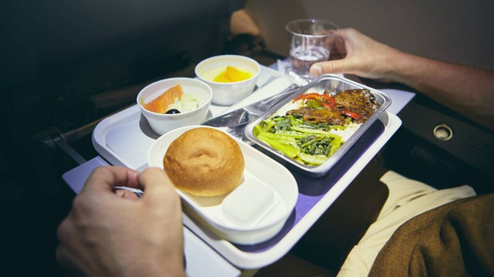 Airline passenger with empty meal tray