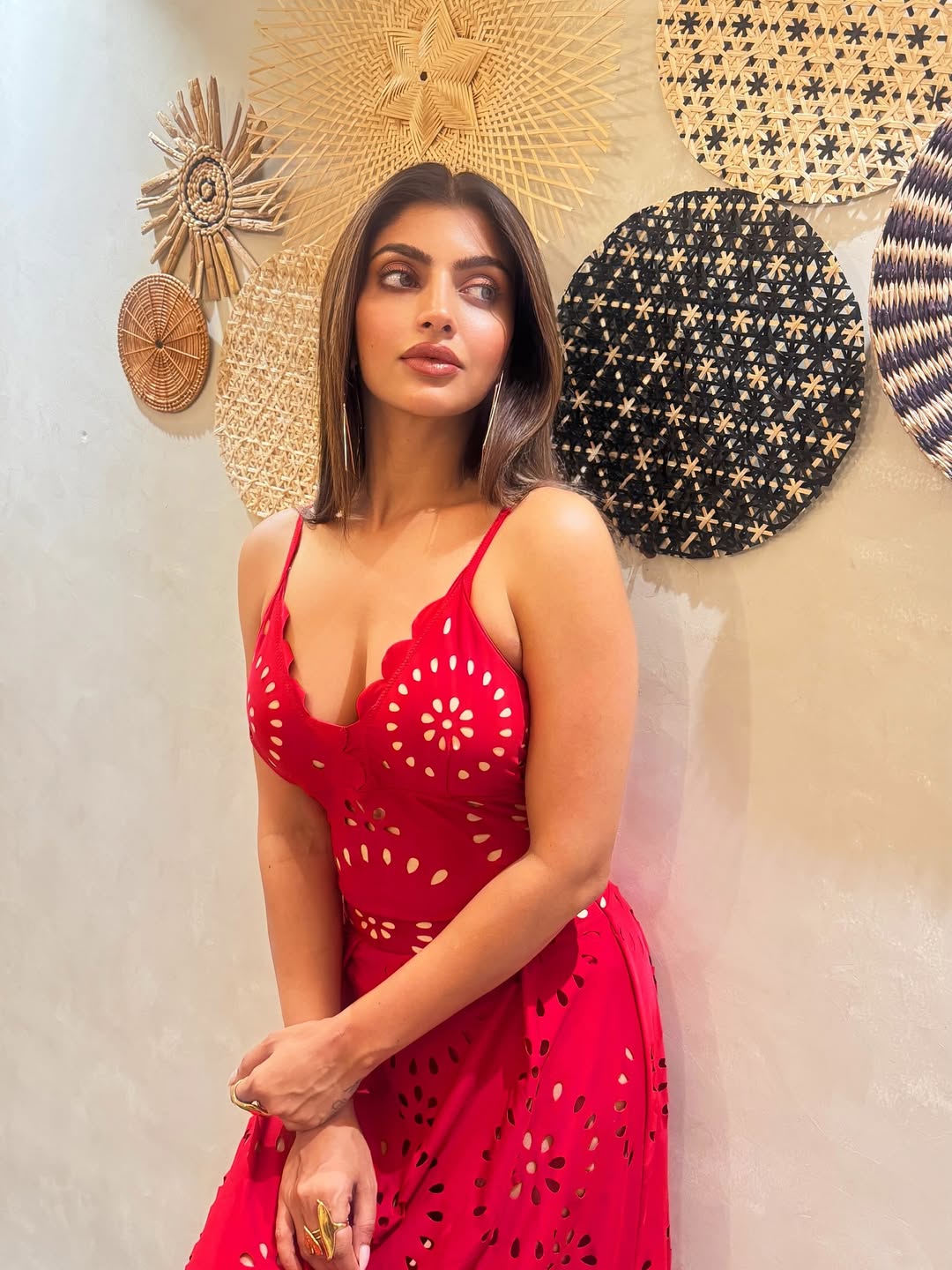 Akanksha Puri Leans Against A Wall In A Red Dress