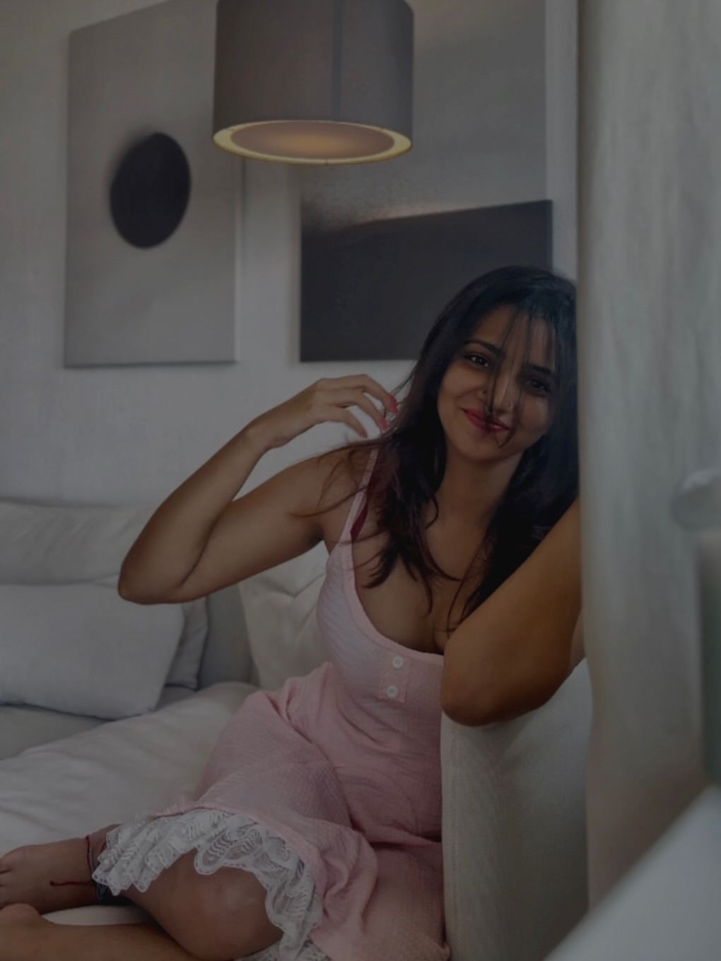 Darsana gives a direct and inviting look in her pretty pink dress.