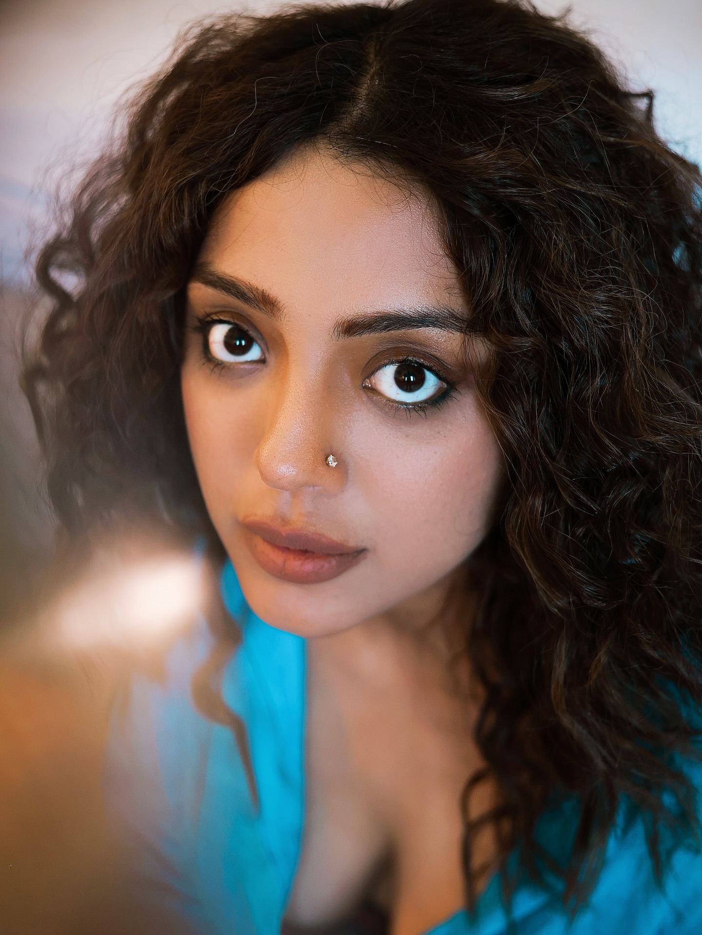 Deviyani Sharma's full look, sitting casually on a patterned rug.