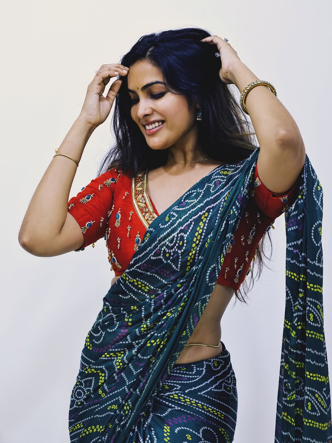 The actress flaunts the stunning design of her daring backless blouse.