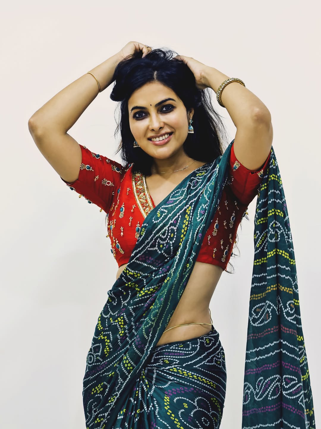 The actress poses elegantly, showing off her toned midriff.