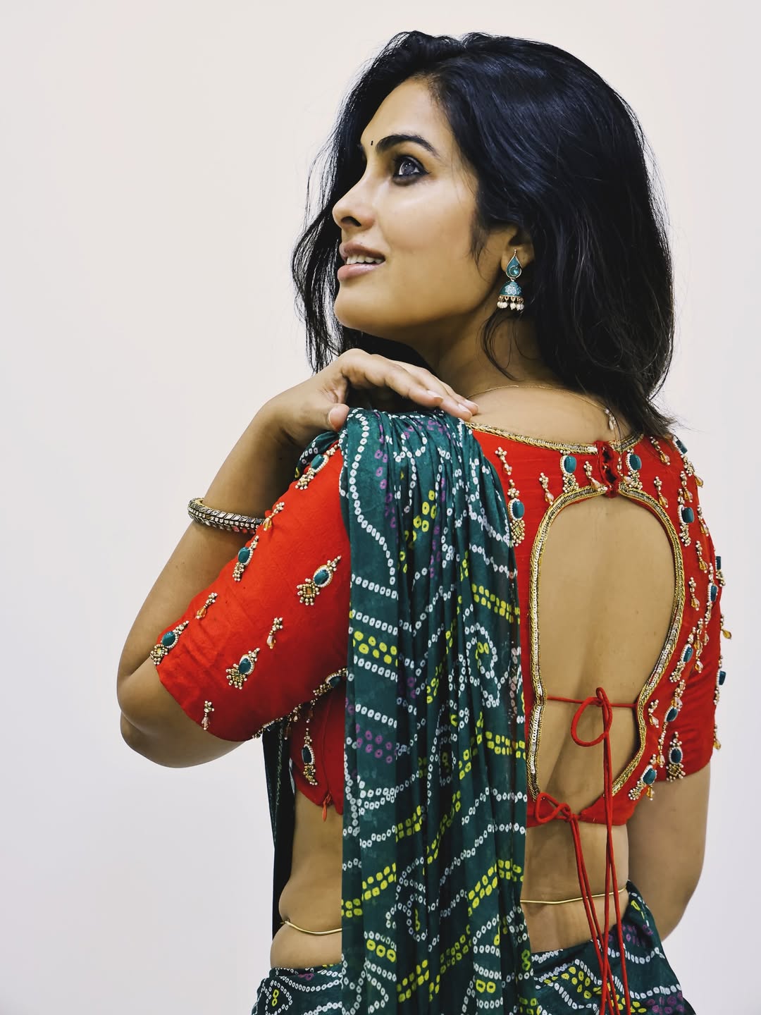 A candid shot of a smiling Divi Vadthya in traditional attire.