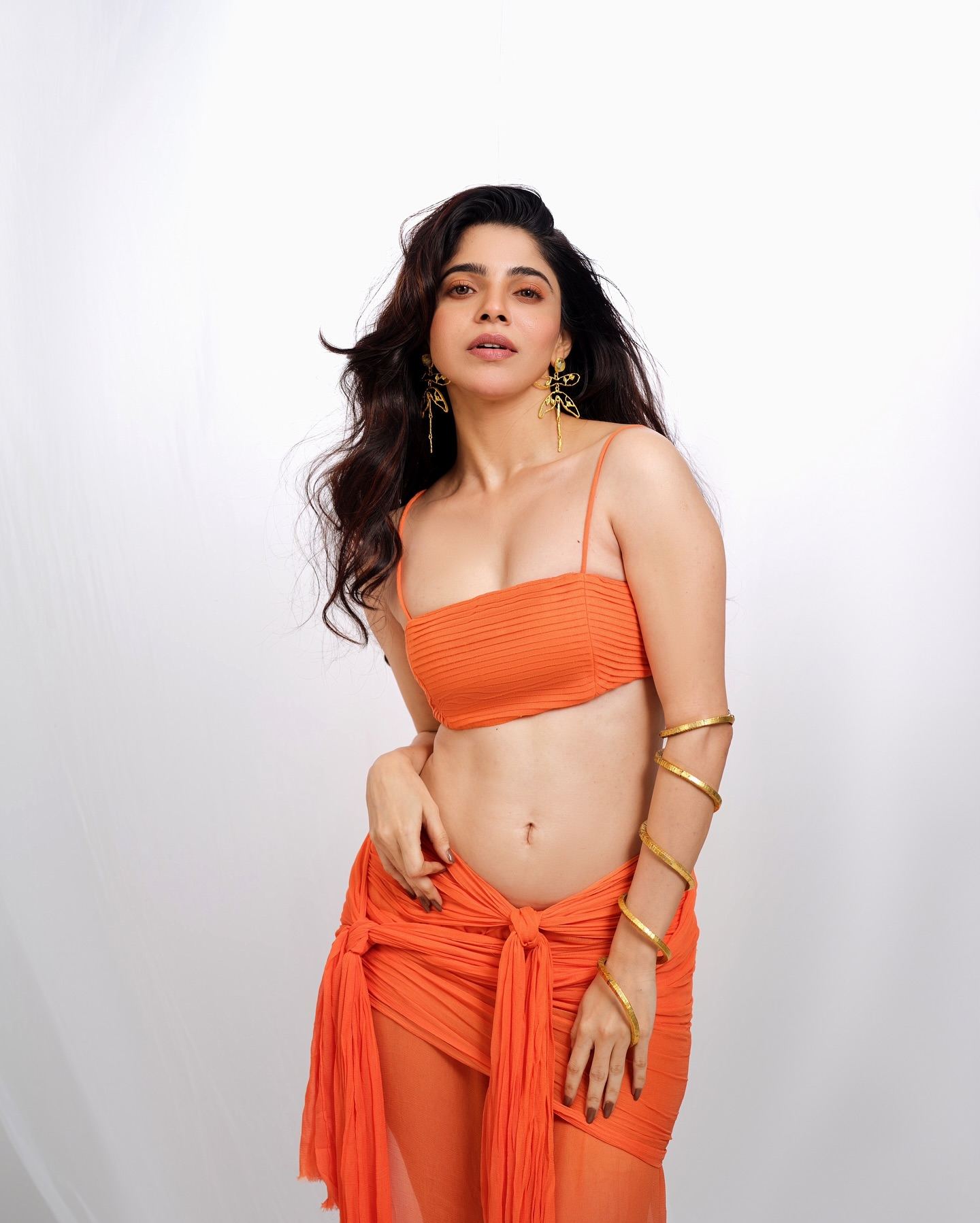 Divyabharathi Stuns In Orange Glam Flaunting Curves