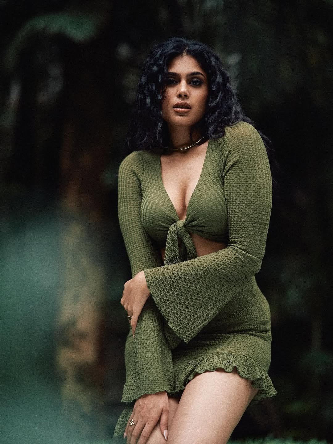 Faria Abdullah poses confidently in a stylish green tie-front top.