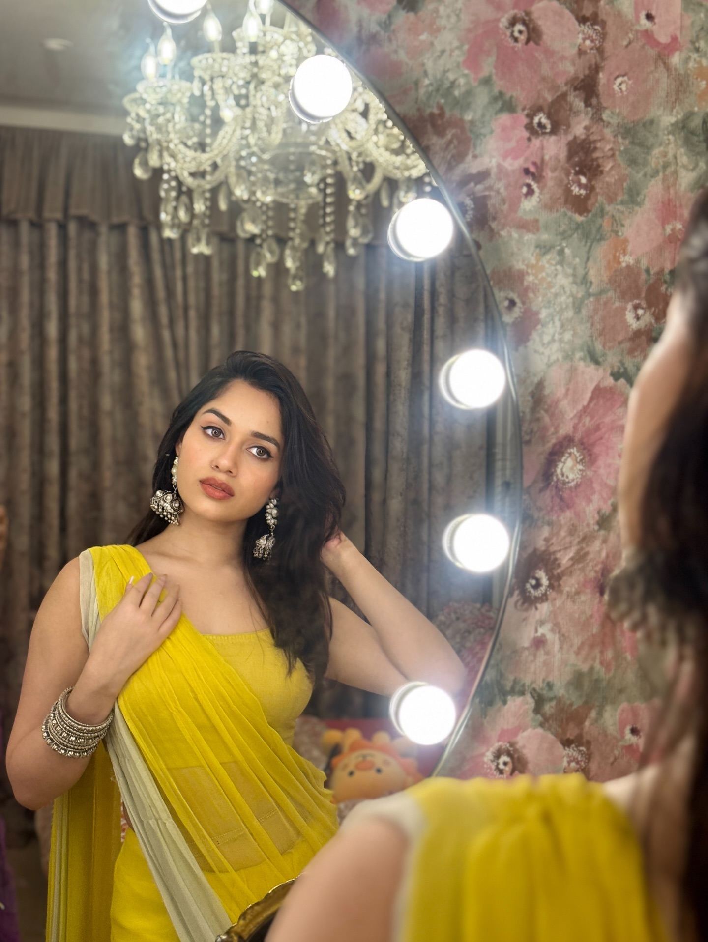 Jannat Zubair posing in a yellow net saree.