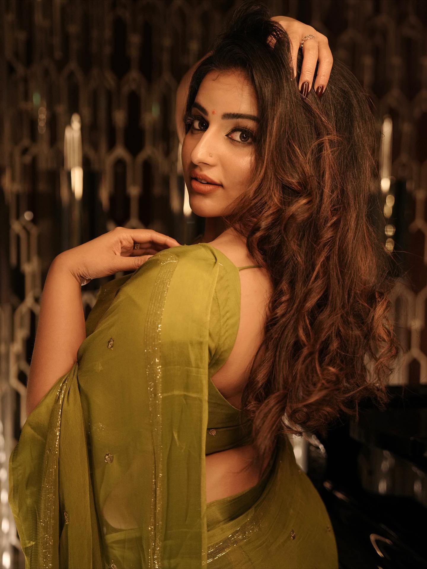 Malavika Menon Poses Gracefully In An Olive Saree.