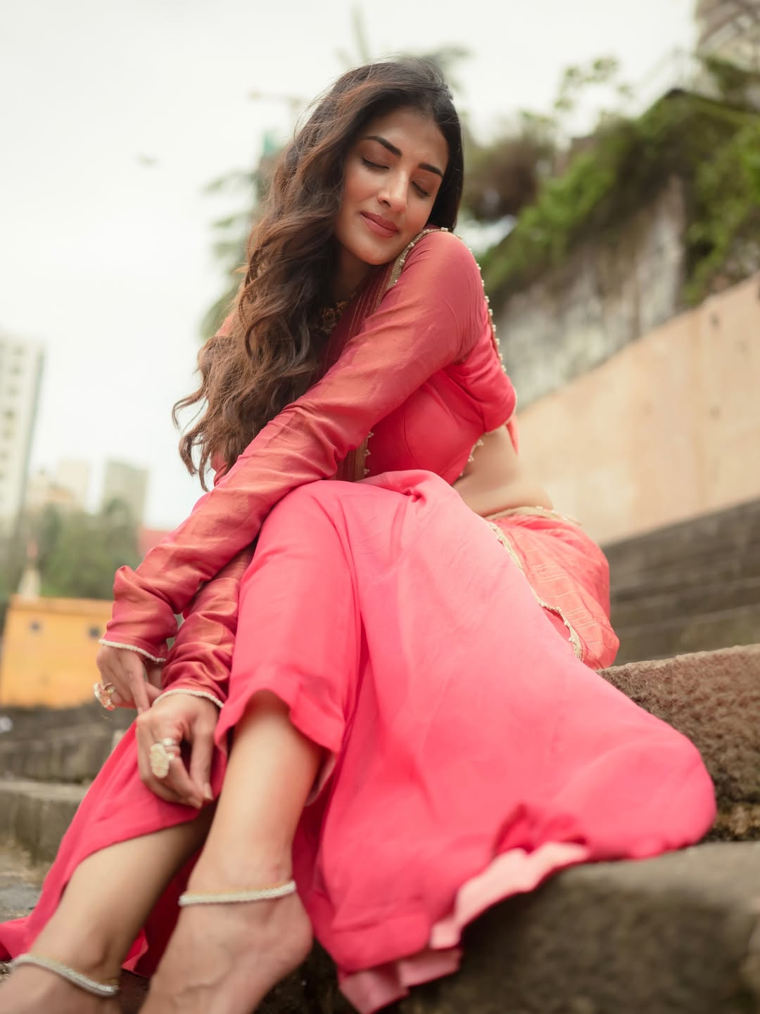 Miloni Jhonsa looks ethereal against a traditional Indian ghat backdrop.