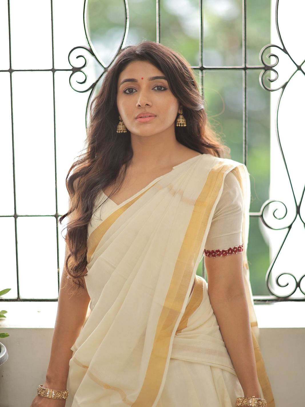 Glamorous festive look of Mirnaa Menon during Onam celebration.