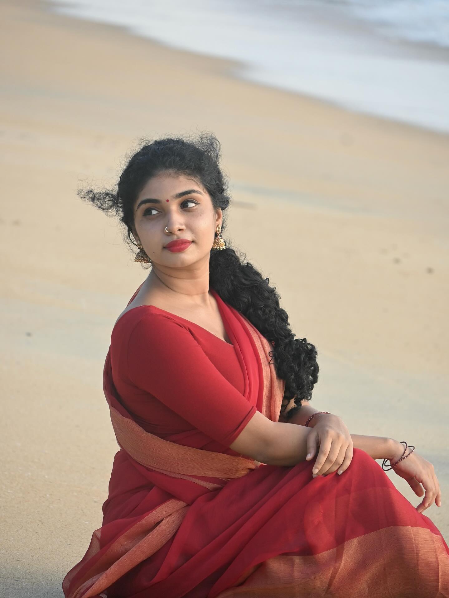 Neeraja shows off her curves and an elegant gold waist chain.