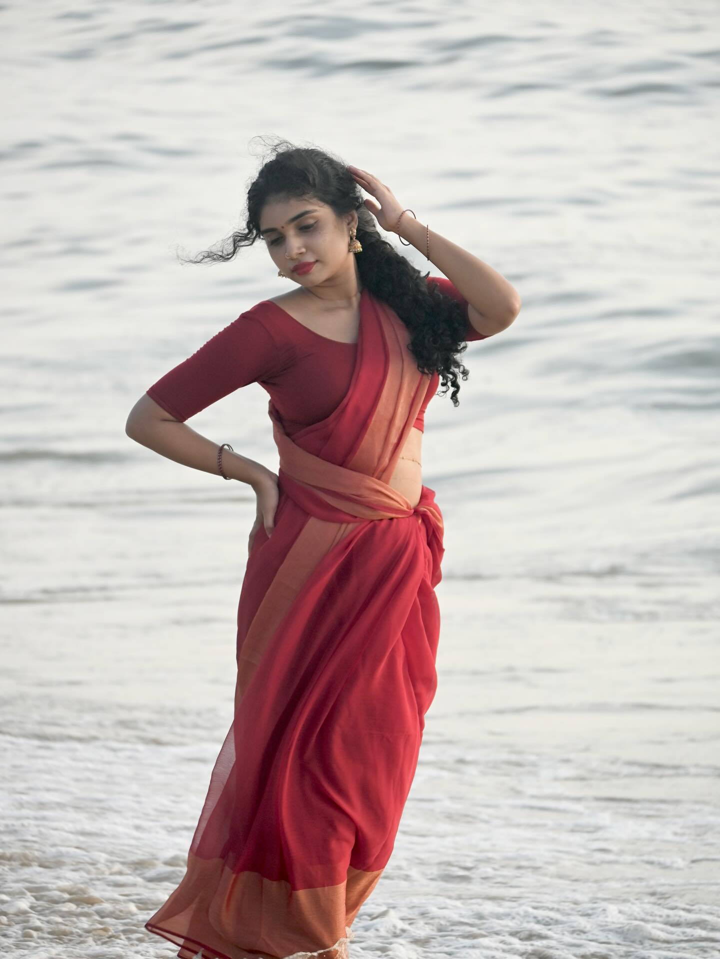Neeraja Ramesh looks stunning while sitting gracefully on the sand.