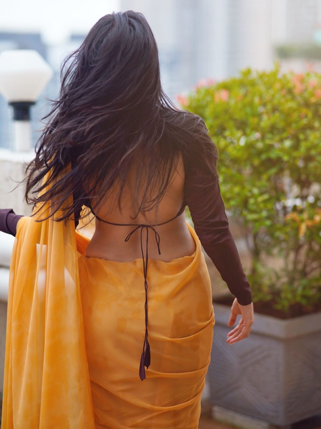 Pratiba's Hair Flows In The Wind On A Rooftop