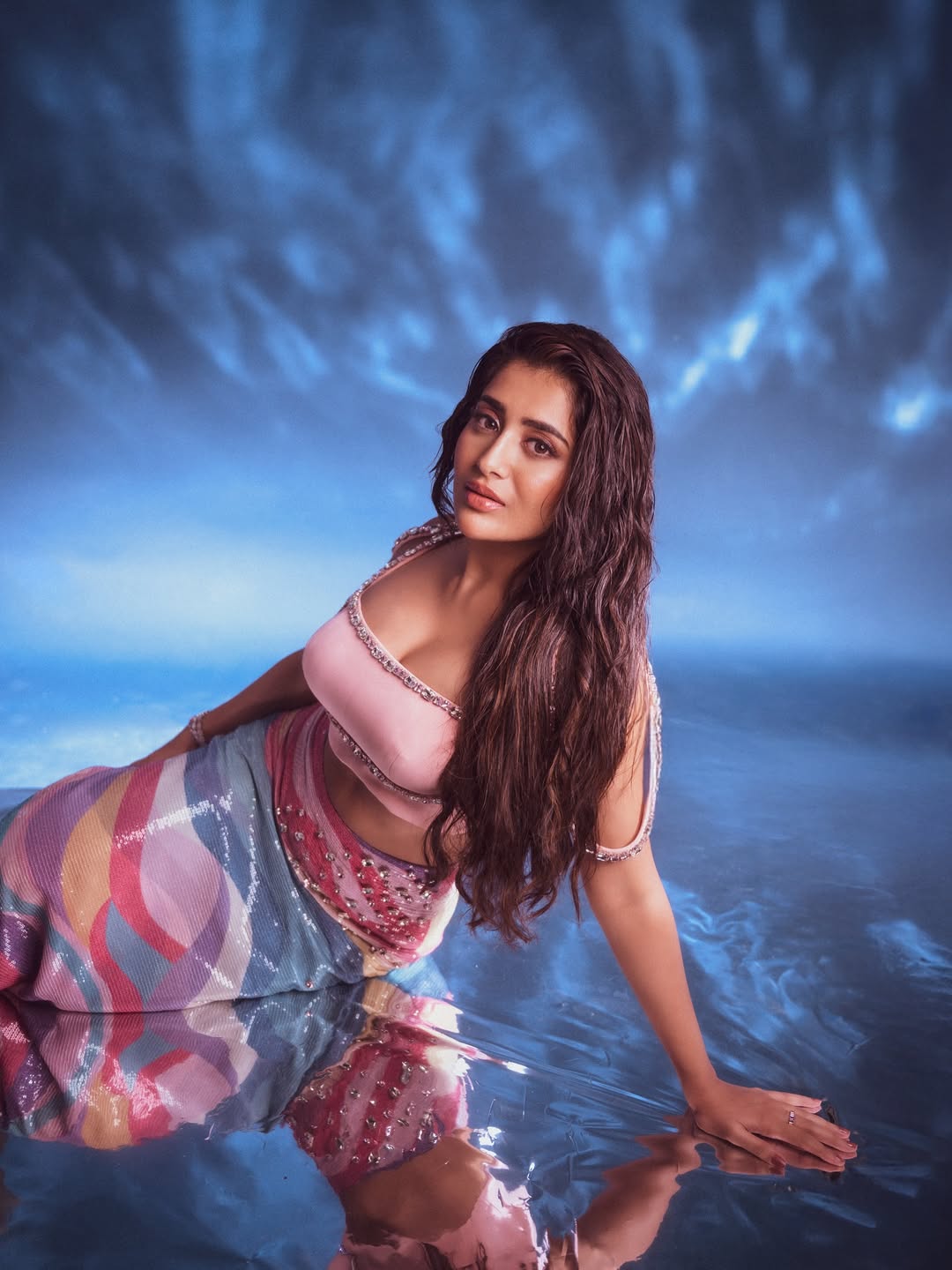 Rashi Singh gives a sultry gaze while reclining in a pink crystal top.