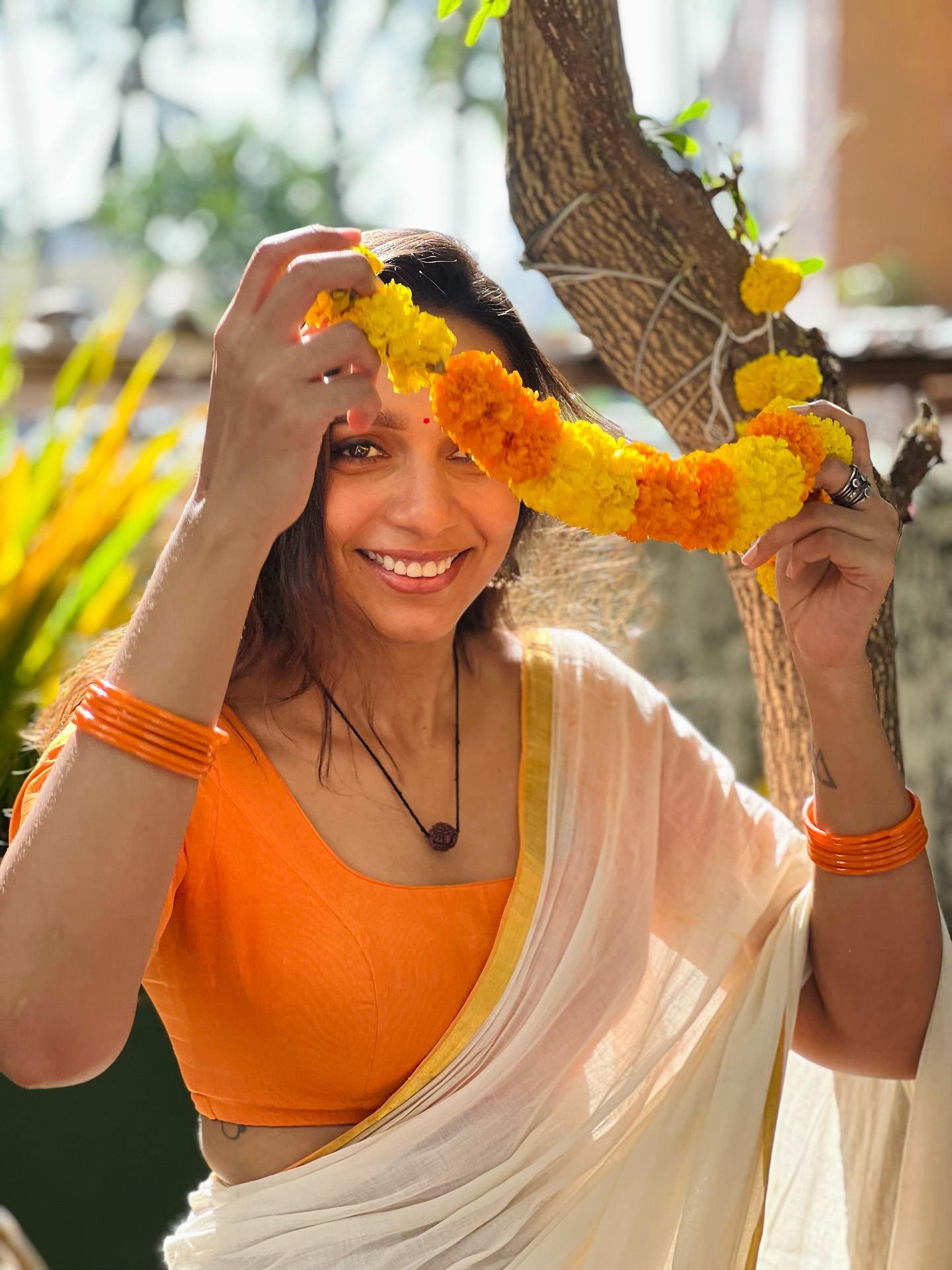 A beautiful shot of Sanchana Natarajan in an orange blouse.