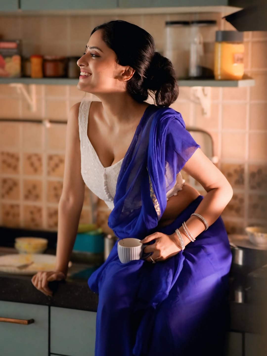 Sanya Thakur flaunts her figure sitting elegantly on the kitchen counter.