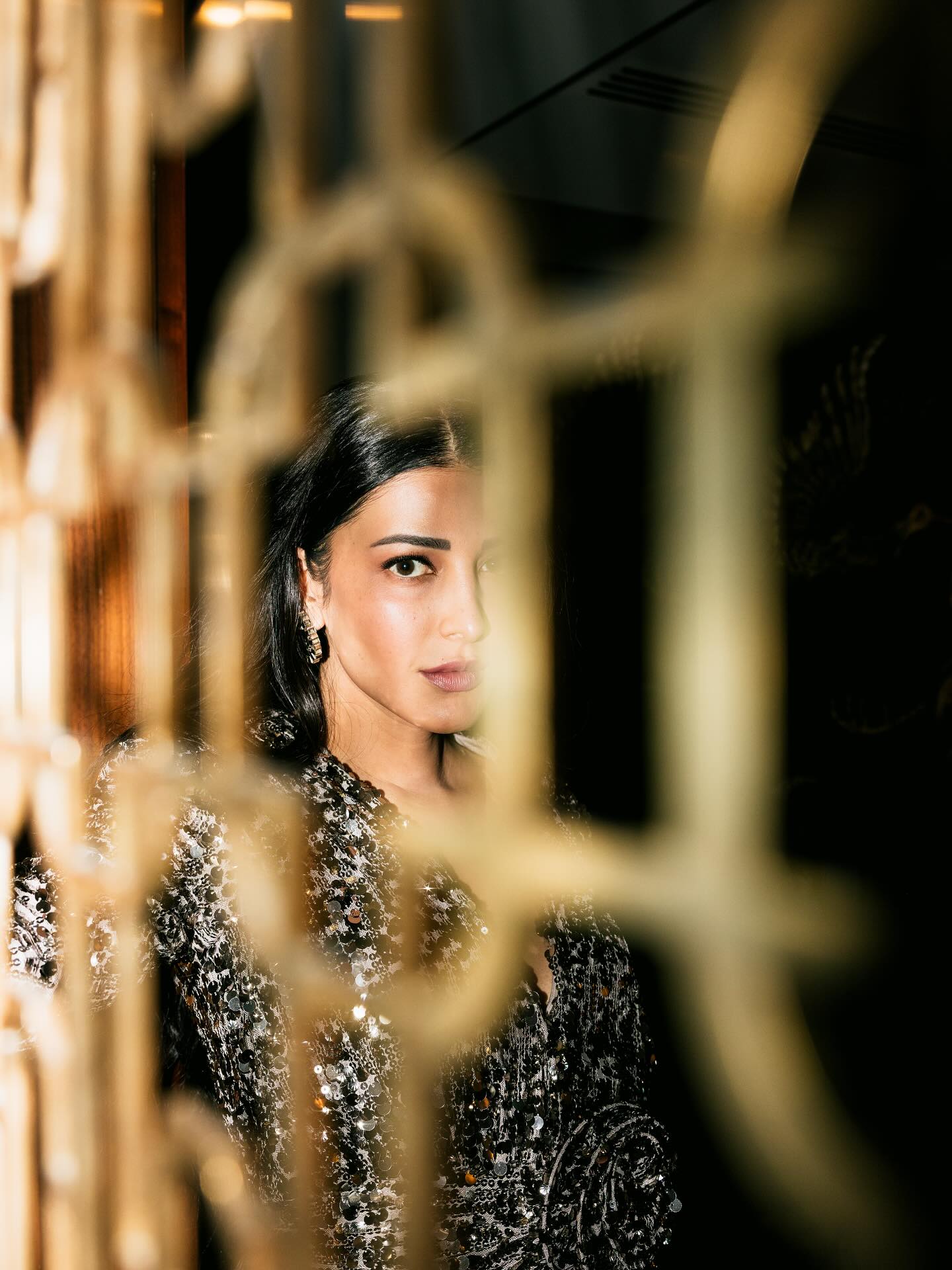 The actress serves a powerful gaze in a shimmering sequin party dress.