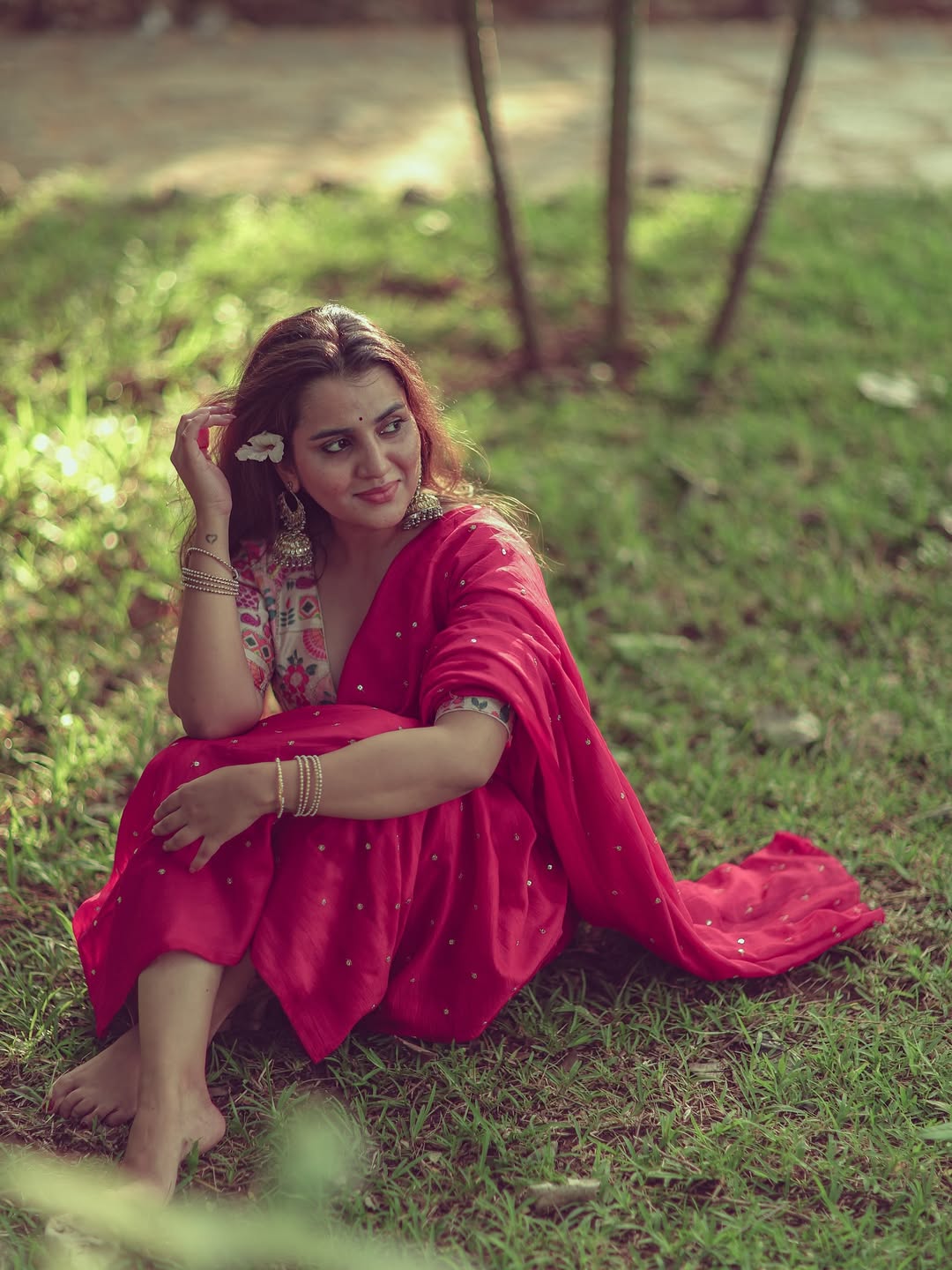The actress gives a direct, confident look in her traditional pink saree.