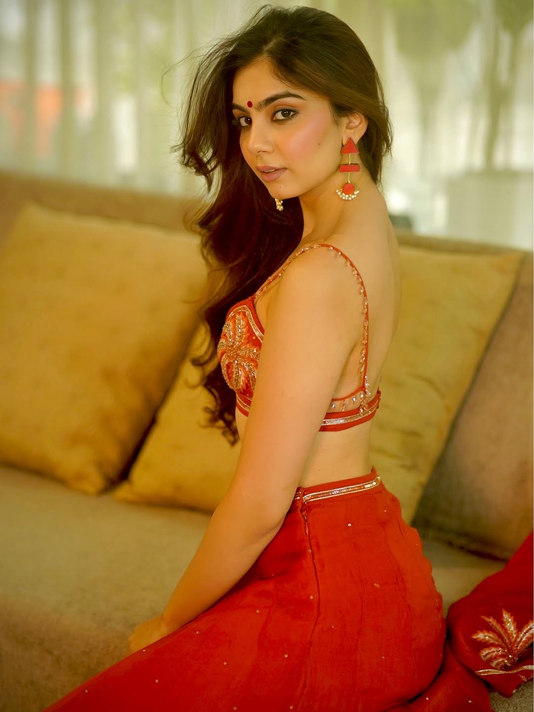 Viddhi Giri's Alluring Pose On A Sofa In Red