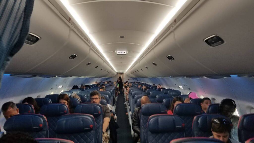 Delta passenger cramped in airplane seat