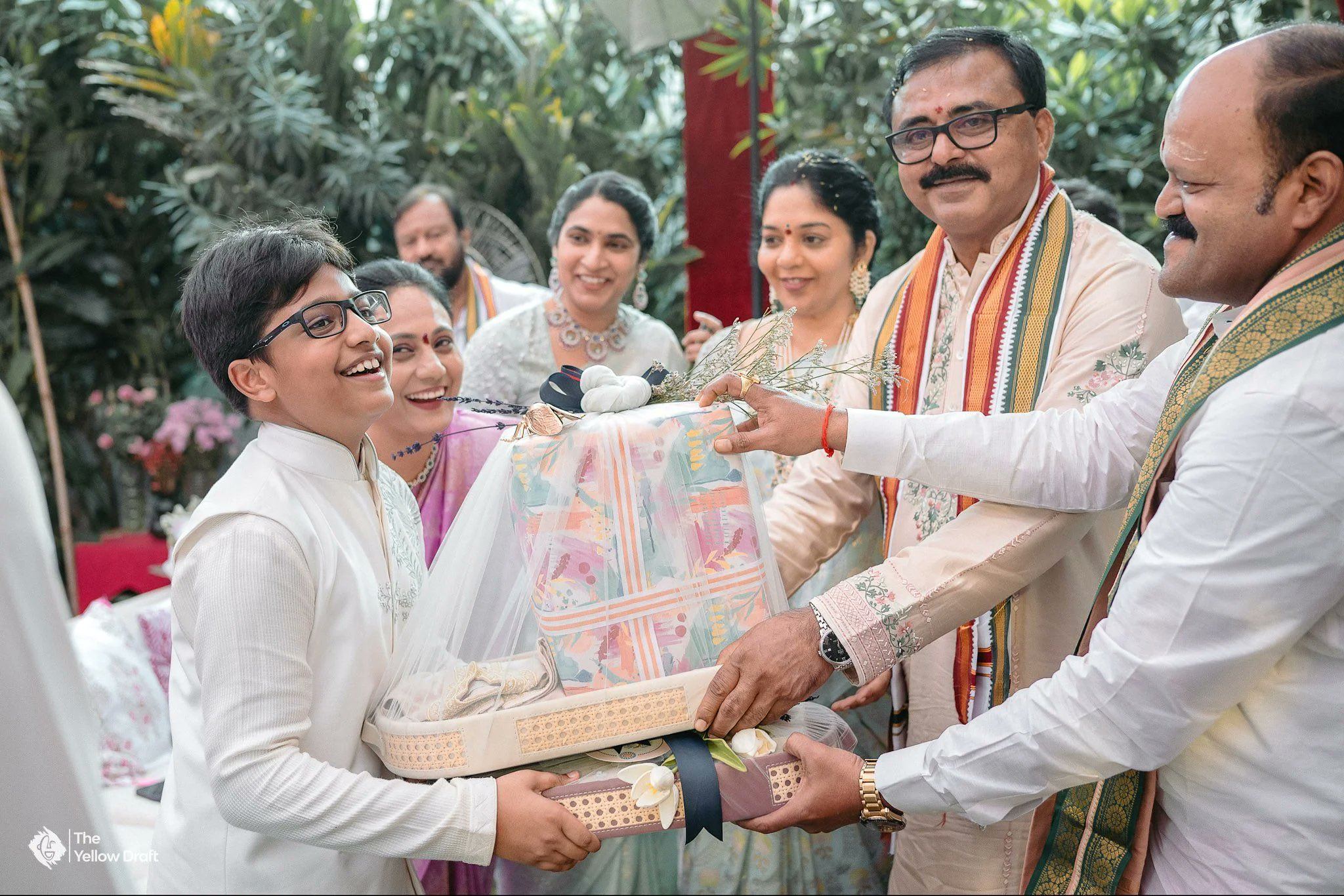 NTR Family Posing with Elegant Floral Gift Box