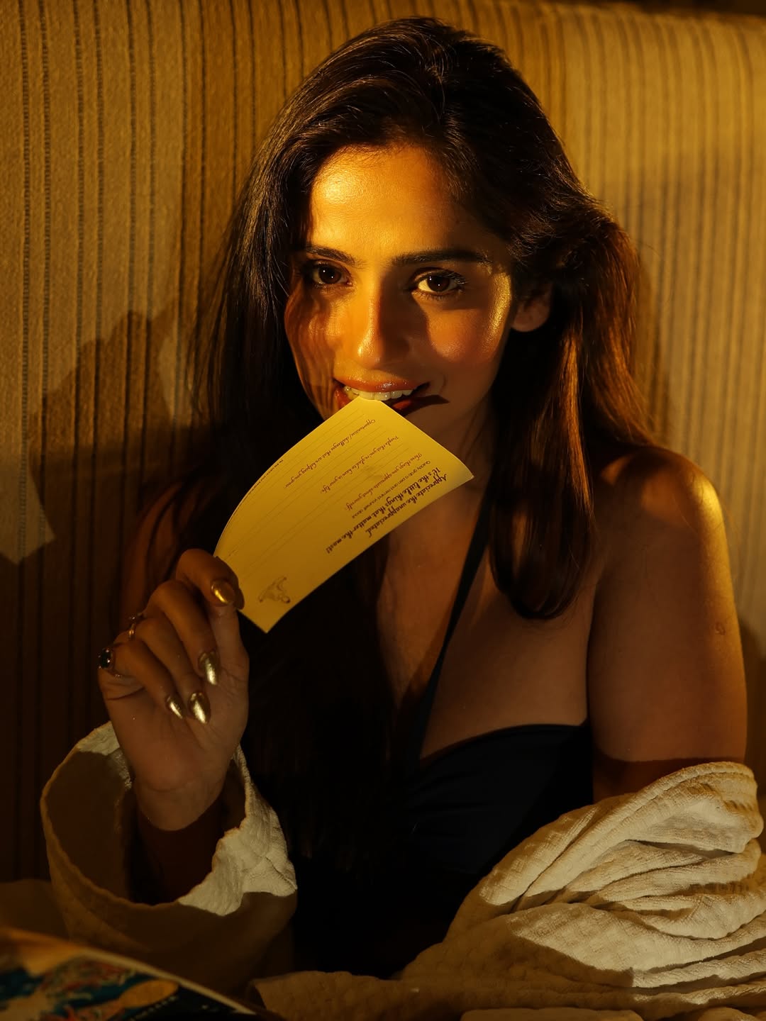 Rose Sardana Holding Card With Playful Smile