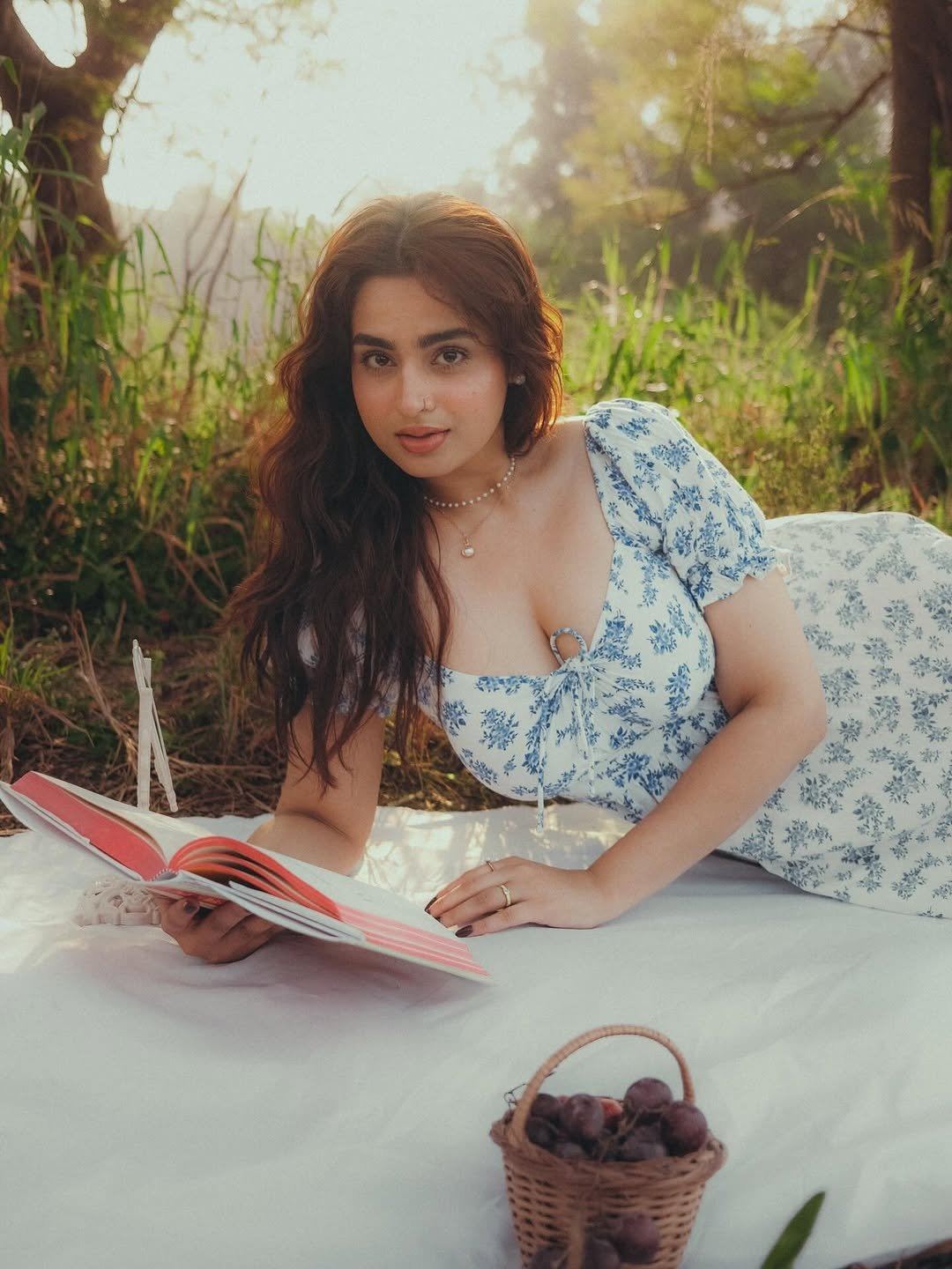 Ayesha Khan Reads A Book Lying On Picnic Mat