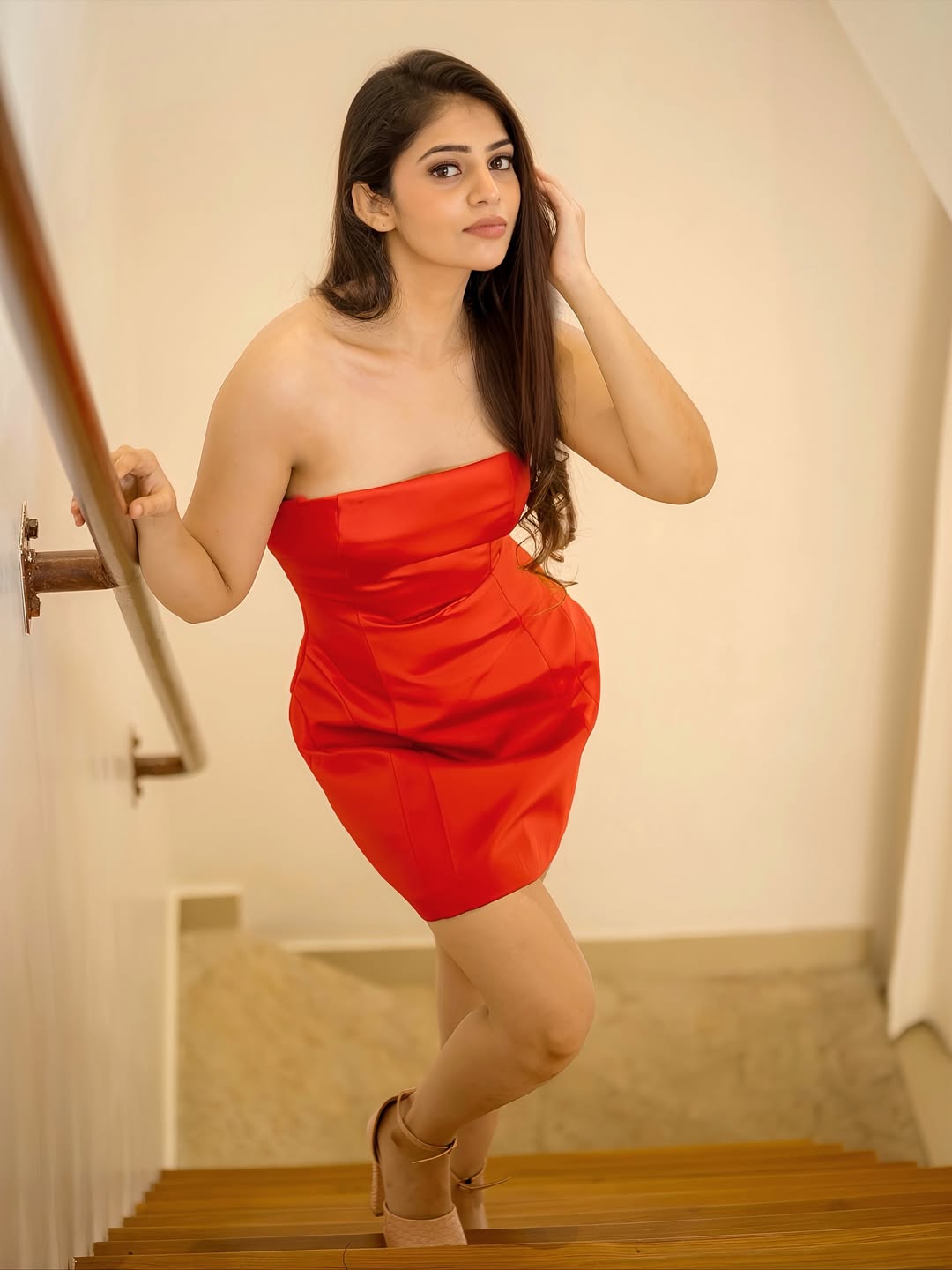 Bandhavi Sridhar Poses On Stairs In A Red Dress