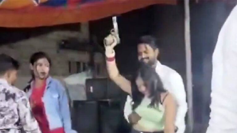 Woman dancing with police revolver in Bihar