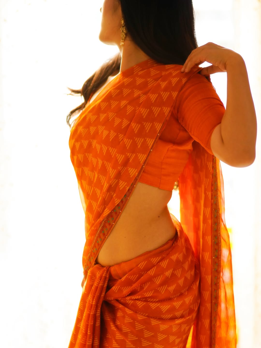 Binita Budathoki's Orange Saree And Gold Bangles