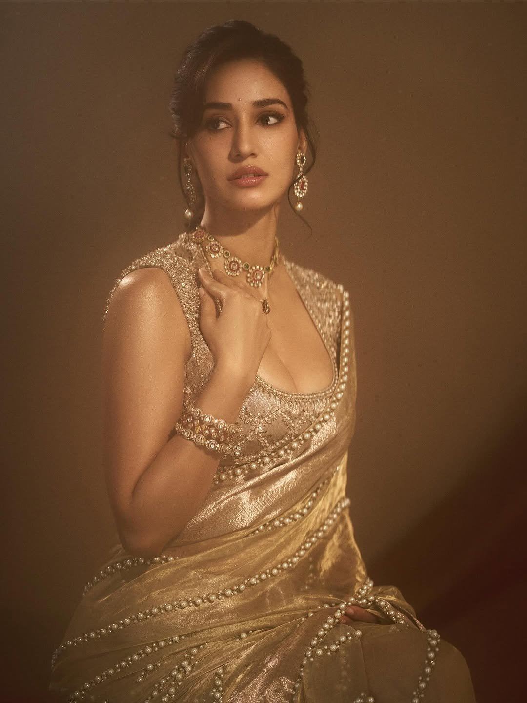Disha Patani's Messy Bun And Golden Saree Look