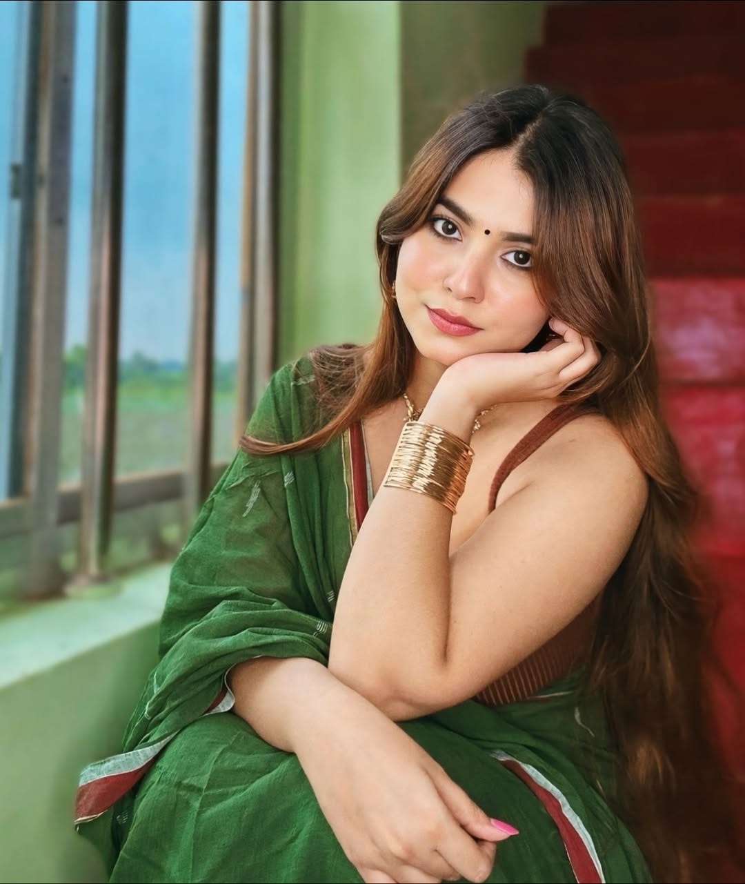 Kanak Mishra Poses By The Window On Red Stairs