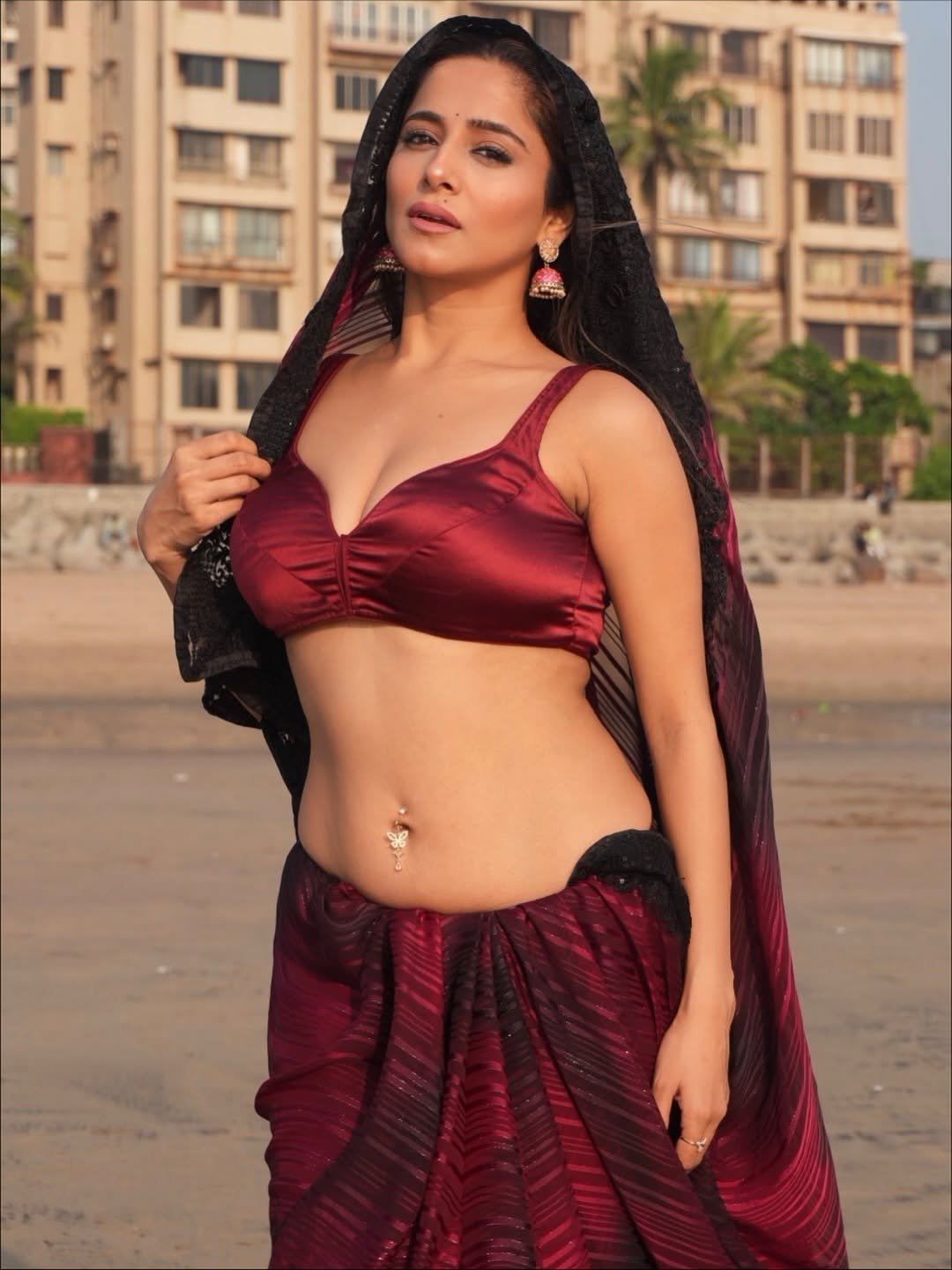 Kate Sharma's Bold Pose In A Red Saree On Beach