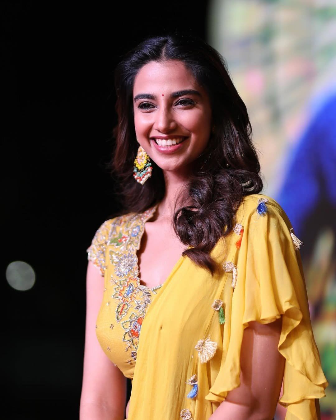 Meenakshi Chaudhary Elegant Smile In Yellow Dress