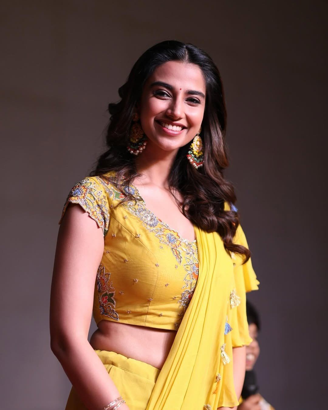 Meenakshi Chaudhary Gorgeous Pose In Yellow Style