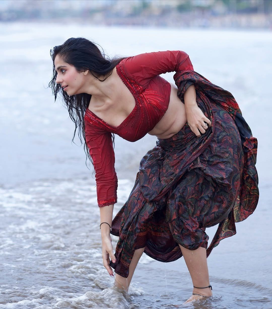 Rose Sardana Kneels In The Ocean Water