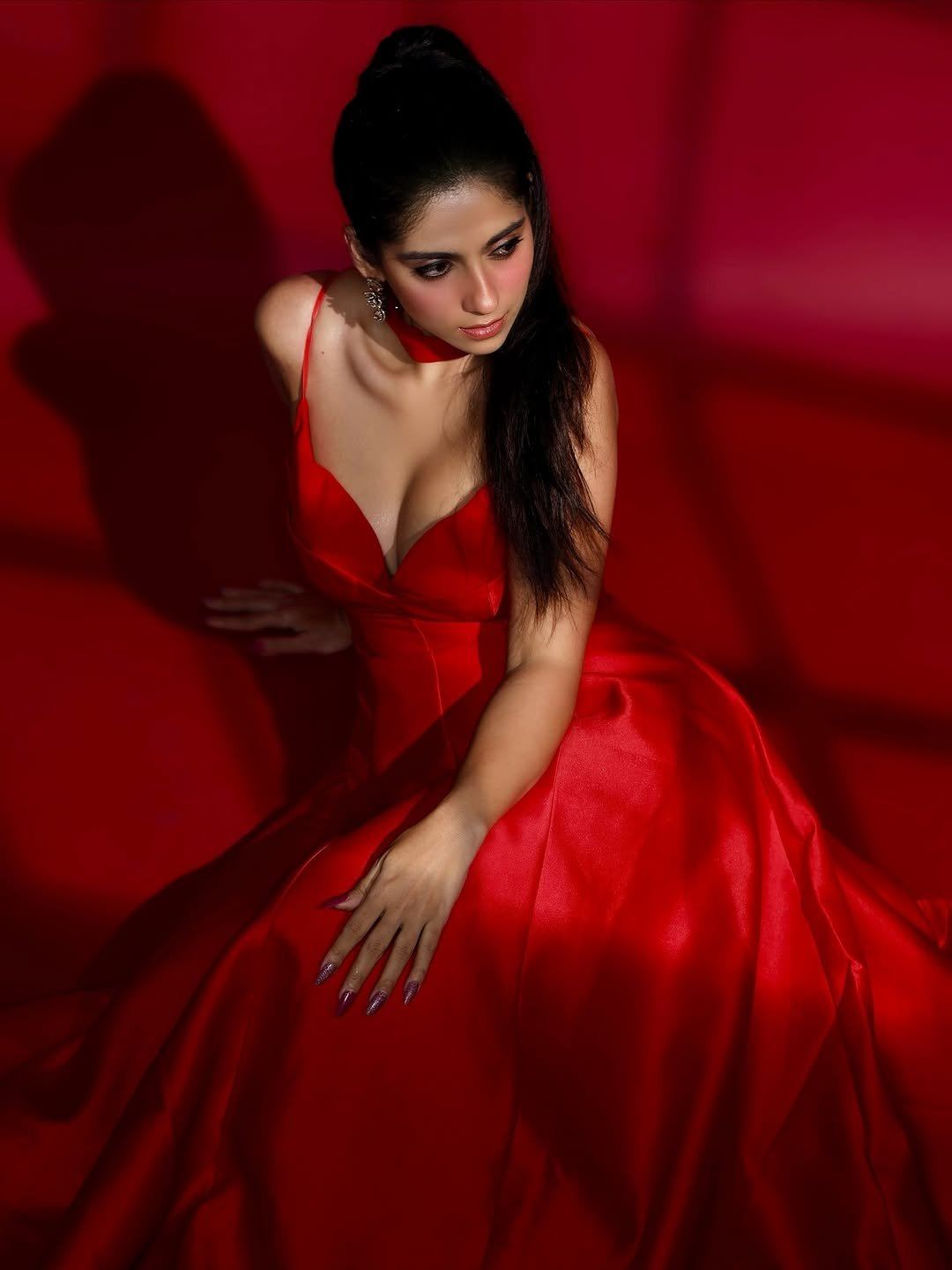 Rose Sardana Sits Gracefully In A Hot Red Dress