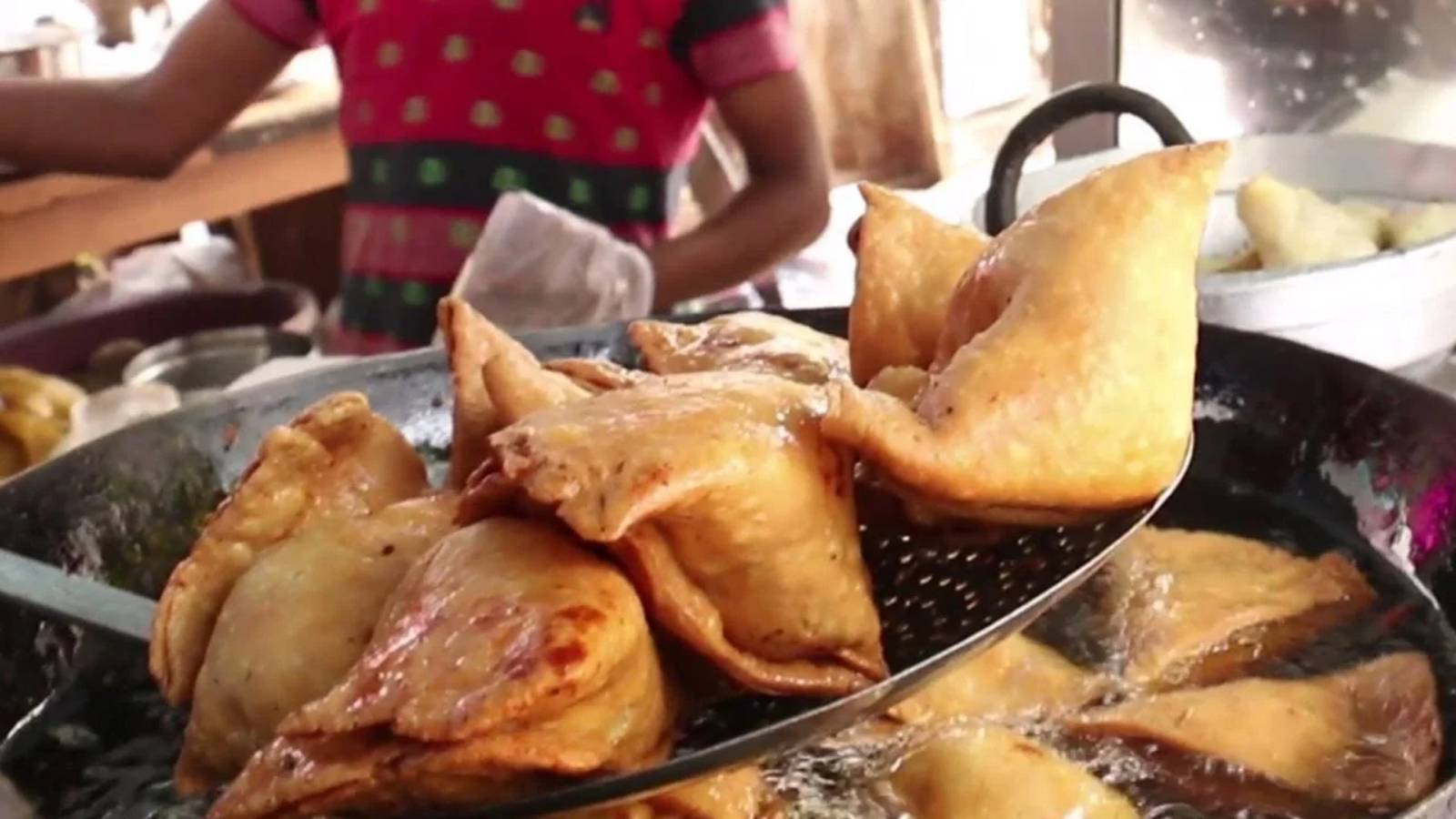Samosas frying in reused oil