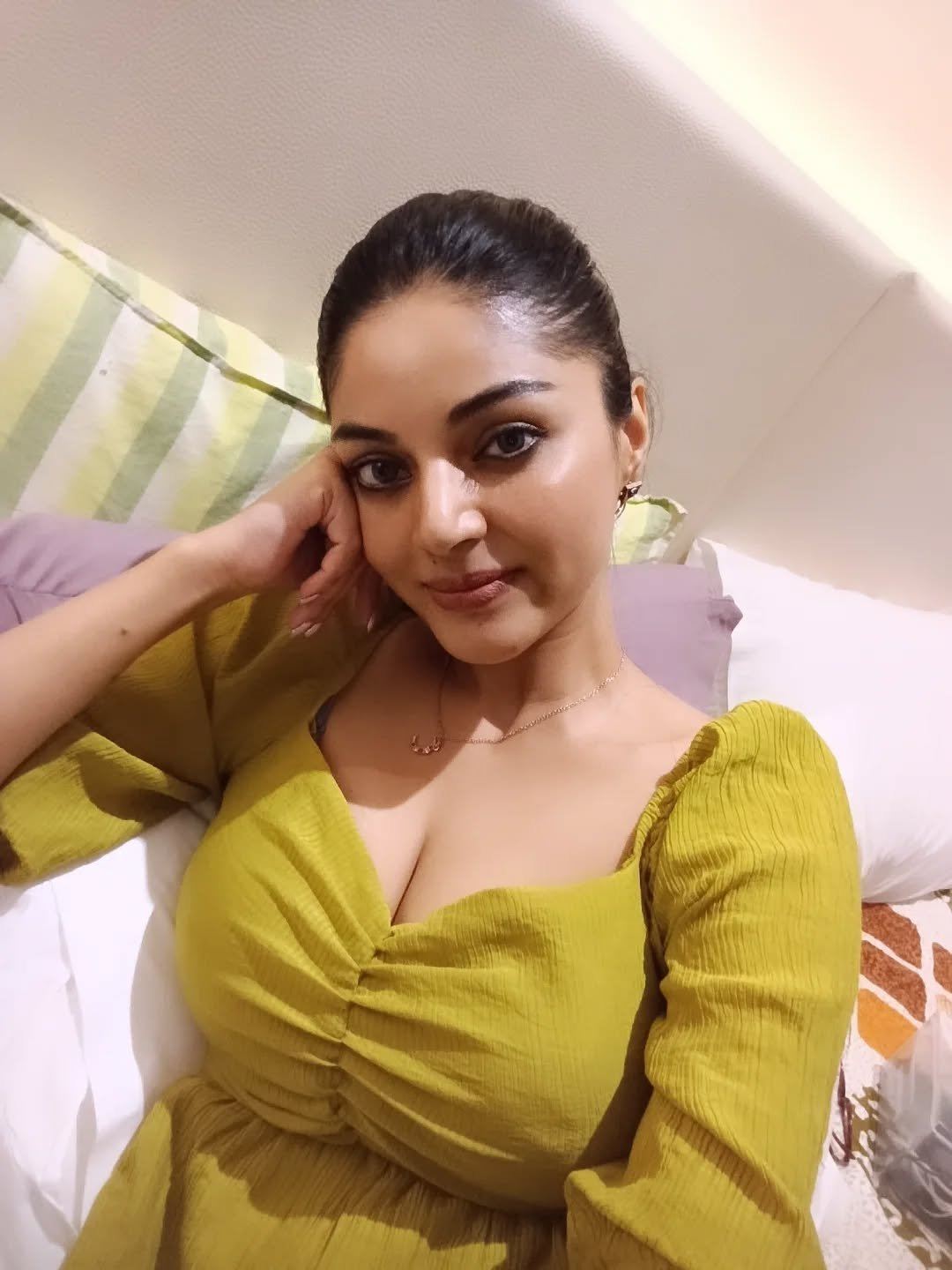 Sanam Shetty Poses Playfully On The Bed In Green