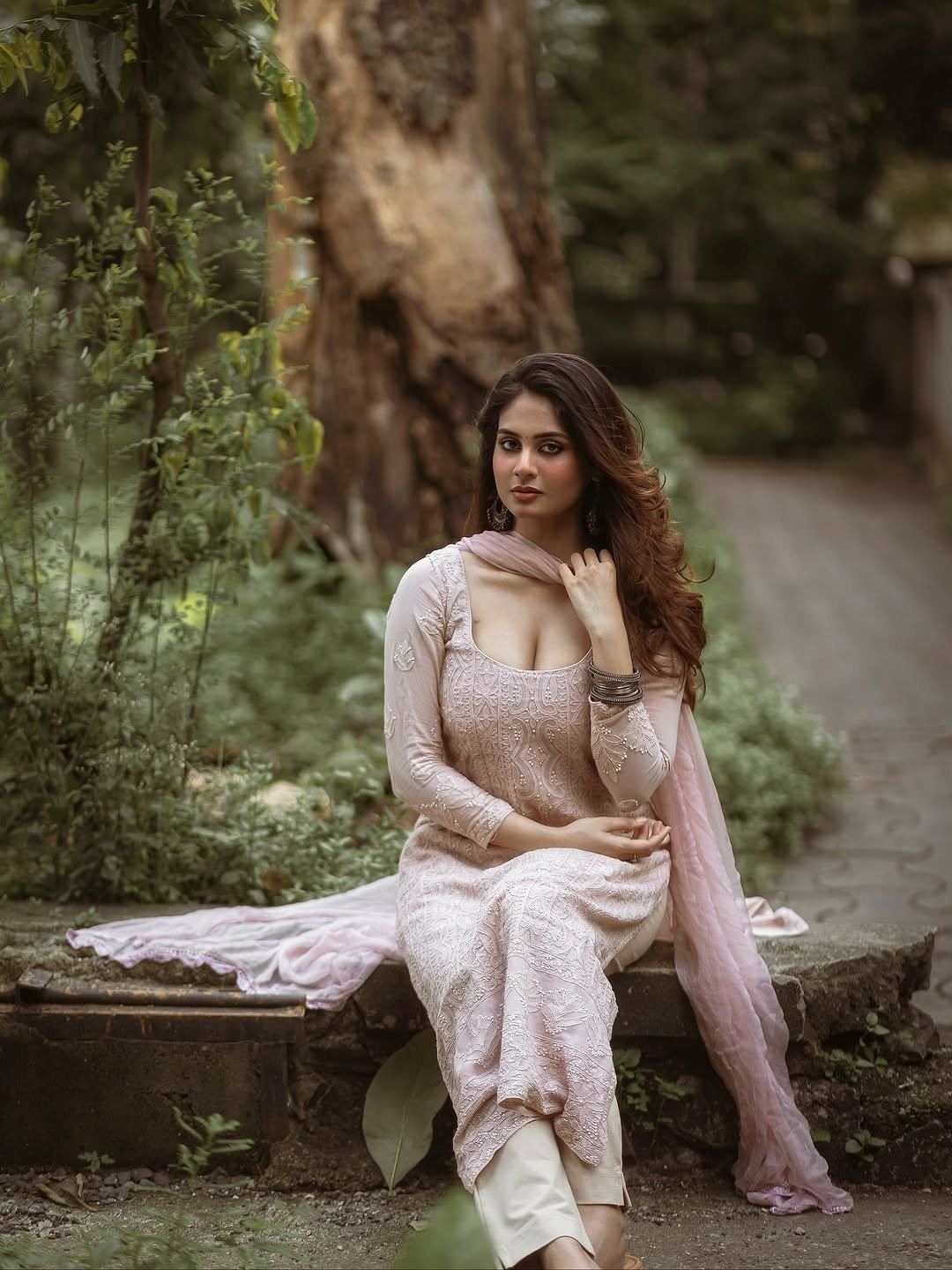 Srushti Bannatti Sits Gracefully On A Stone Bench