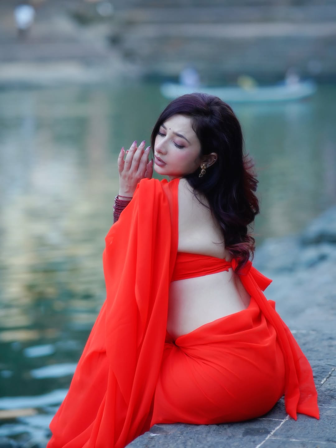 Amrita Mishra Hands In Hair Pose By The Water