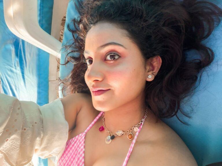 Deepika Pilli relaxed pose near boats at beach