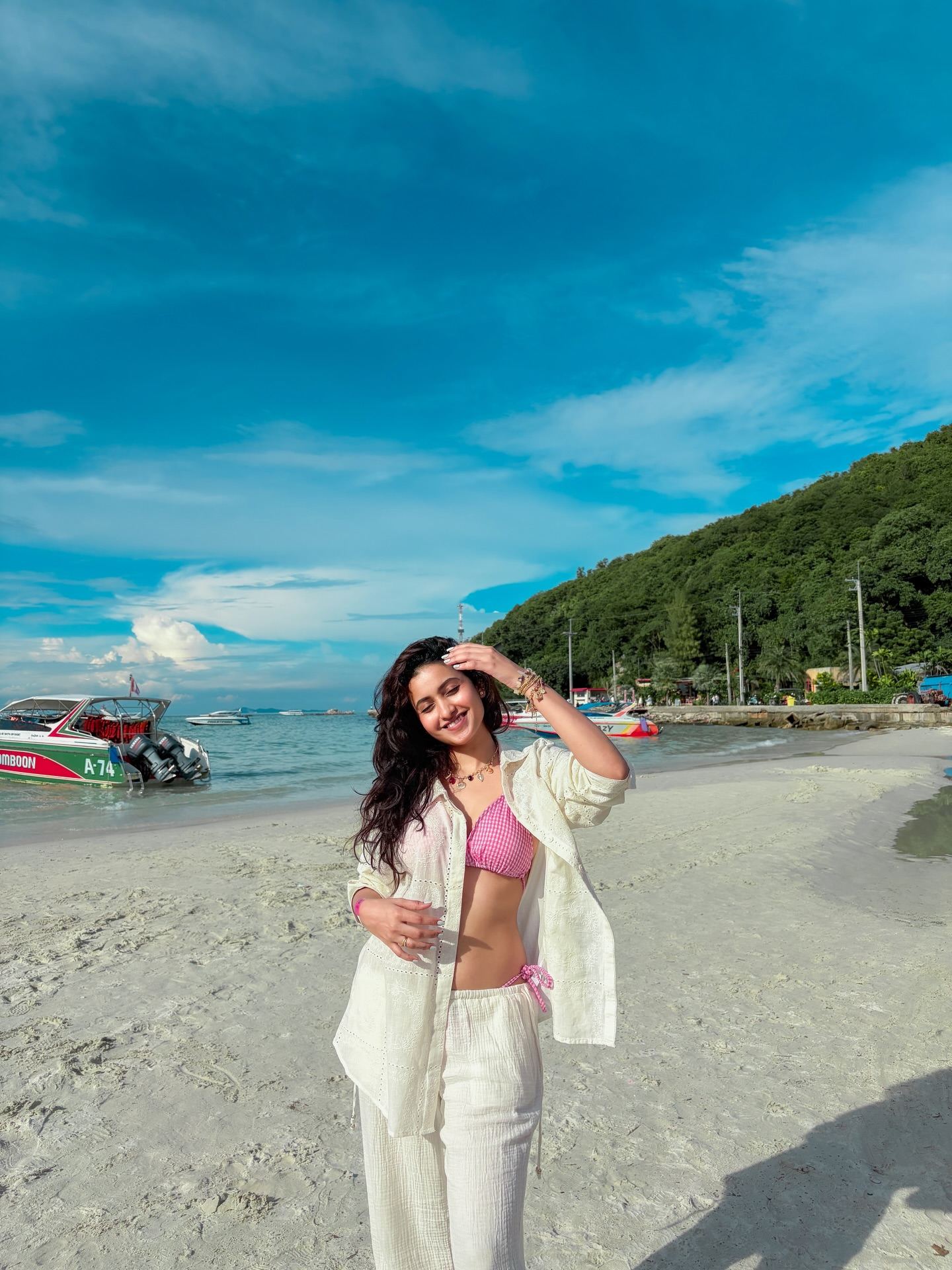 Deepika Pilli posing on beach in white outfit