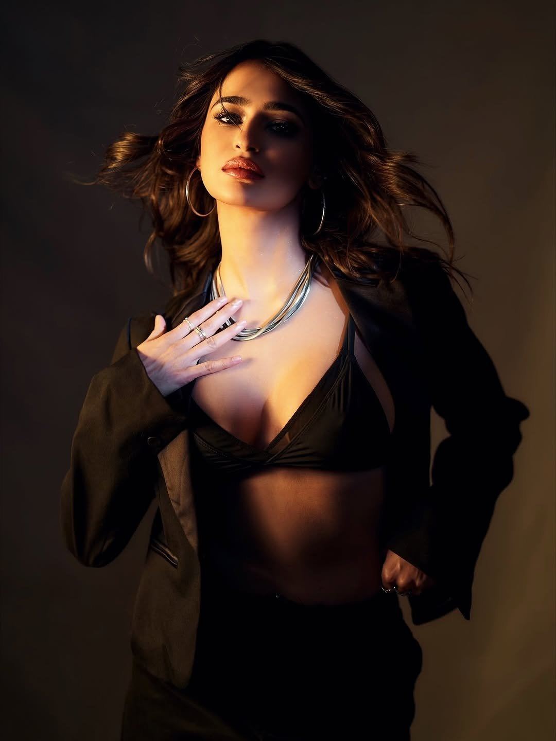 The Black Bralette And Blazer Hug Her Curves