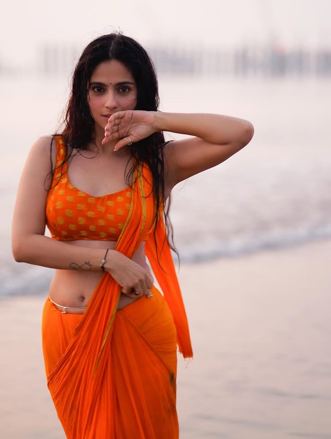 Rose Sardana Arching Back In Wet Orange Saree Look