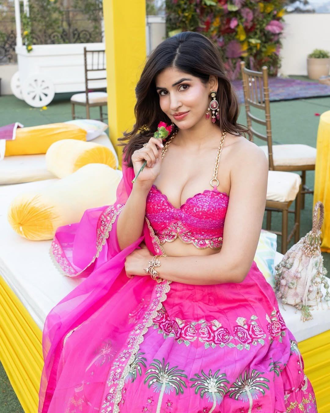 The Actress Poses Gracefully With A Red Rose