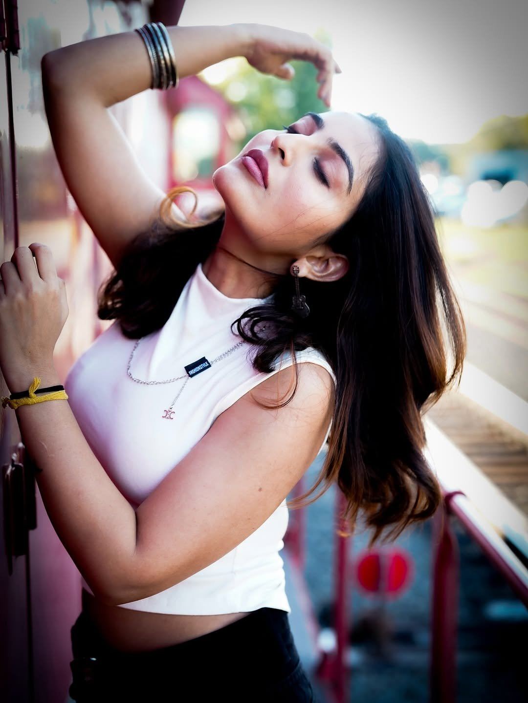 Ananya Nagalla Posing Boldly Against Red Train