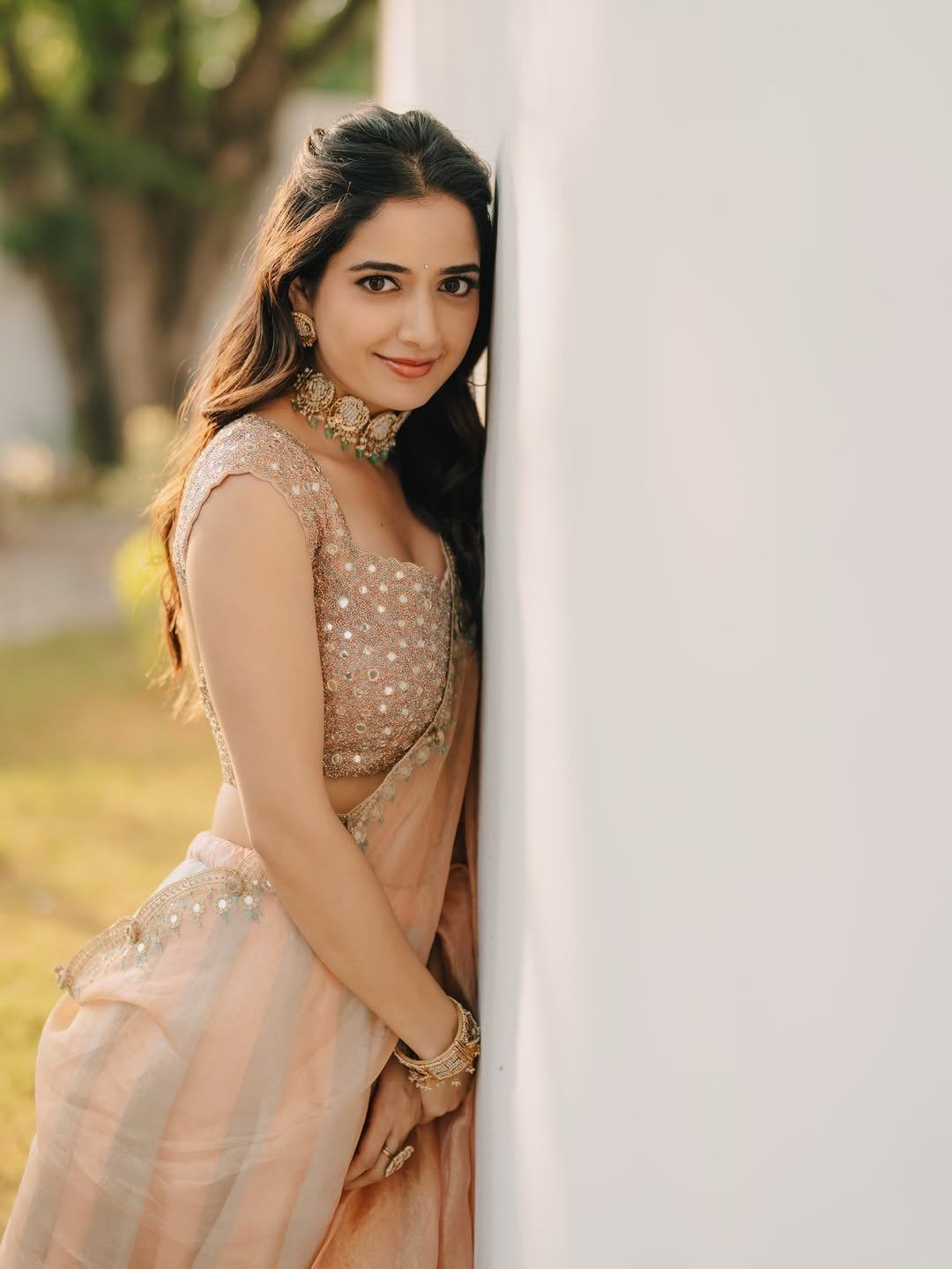 Ashika Ranganath Leaning On White Wall Gracefully