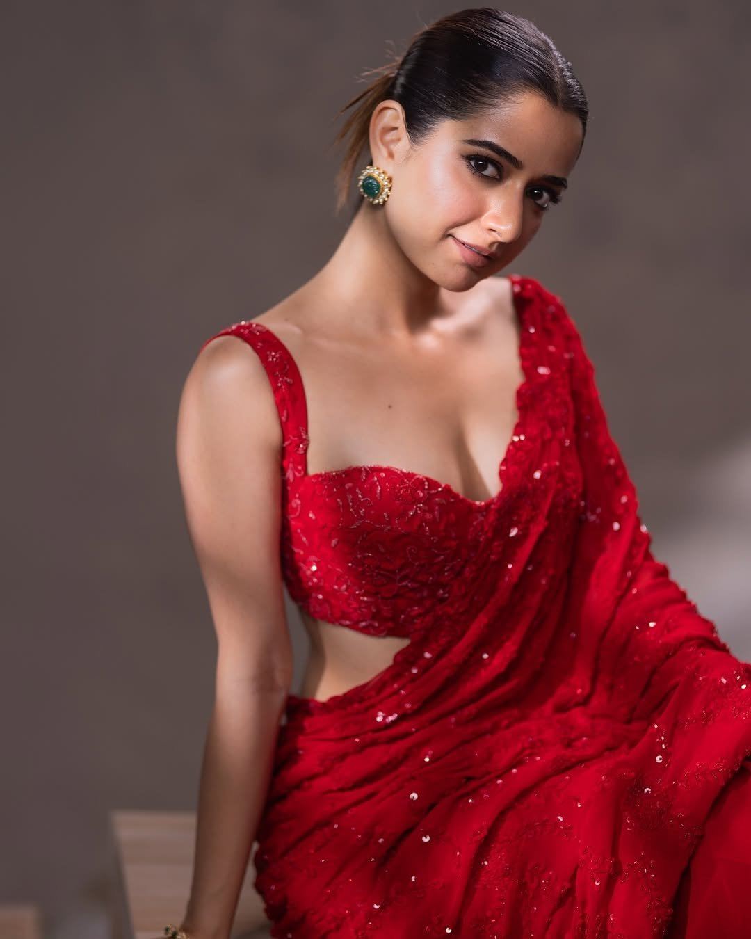 Ashika Rangnath Posing In Bold Red Sequin Saree.