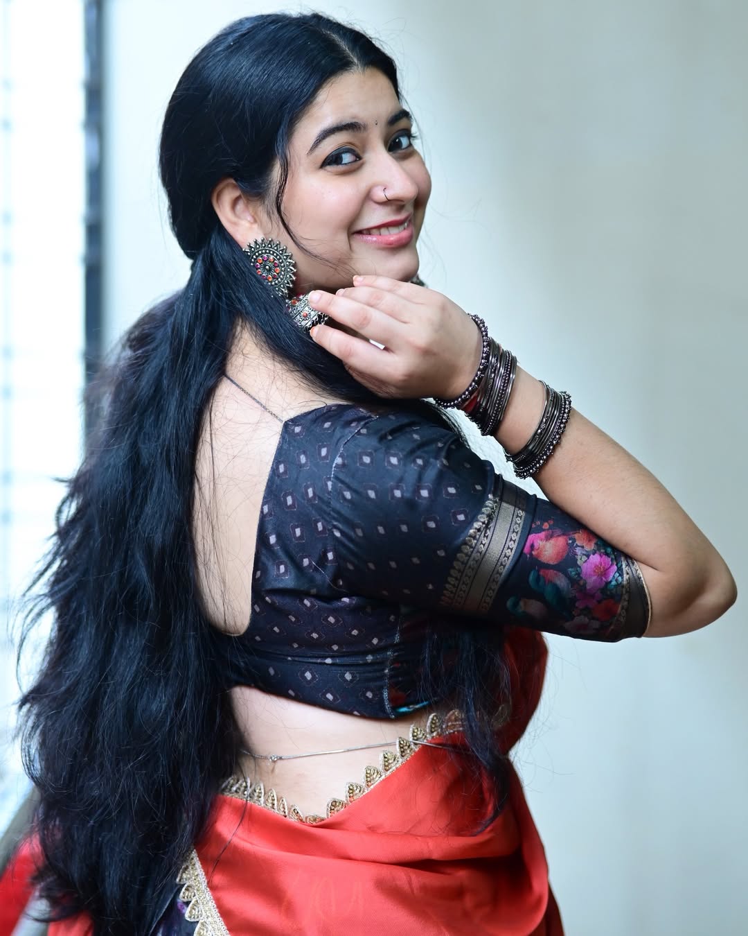 Close Up Of K Sudha Wearing Designer Red Saree.